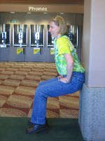 Amy Lesan does a wall sit
in the airport.